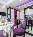 Роскошная кухня-столовая с пурпурными портьерами и мебелью